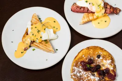 three plates of breakfast food on a table at Gallery Townhouse & Home in Porto