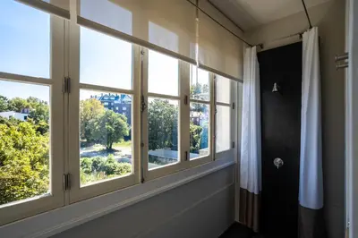 a room with three windows with a view at Gallery Townhouse & Home in Porto