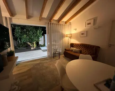 a living room with a couch and a table at Douro Pateo House in Vila Nova de Gaia