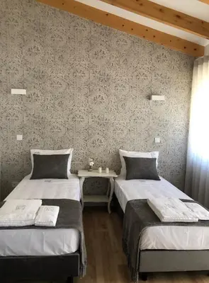 two beds sitting next to each other in a room at Douro Pateo House in Vila Nova de Gaia