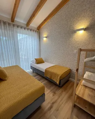 a bedroom with two beds and a window at Douro Pateo House in Vila Nova de Gaia