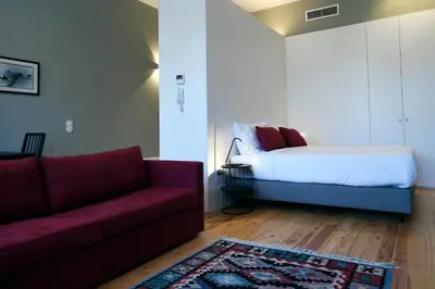 a living room with a couch and a bed at Trendy Flats Fontainhas in Porto