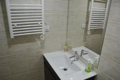 a bathroom with a sink and a mirror at Portoo Blue Apartments - Amazing in Vila Nova de Gaia