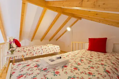 a bedroom with two beds and a red pillow at APOSENTUS - Clerigos Tower view Mezzanine in Porto