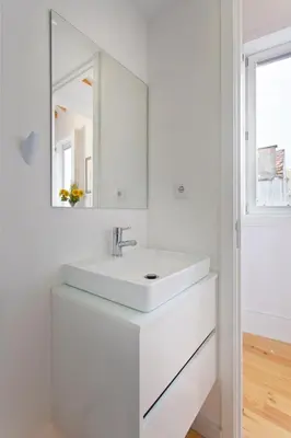 a white bathroom with a sink and a mirror at APOSENTUS - Clerigos Tower view Mezzanine in Porto