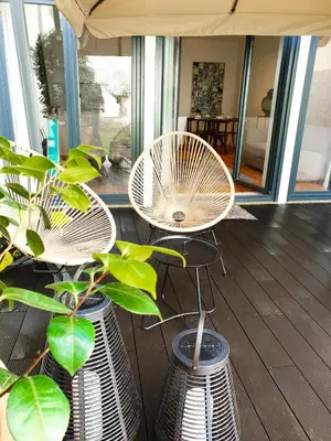 a patio with a table and chairs and plants at Stayin Apartments - Rua do Sol in Porto