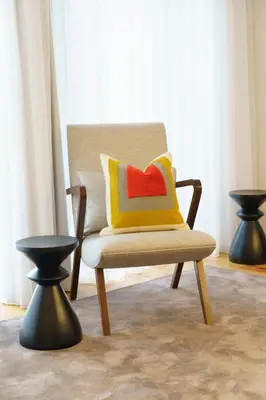 a chair with a colorful pillow in a room at Stayin Apartments - Rua do Sol in Porto