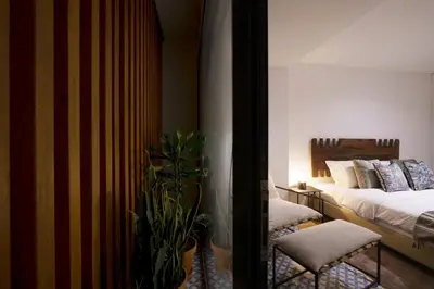 a bedroom with two beds and a potted plant at Stayin Apartments - Rua do Sol in Porto
