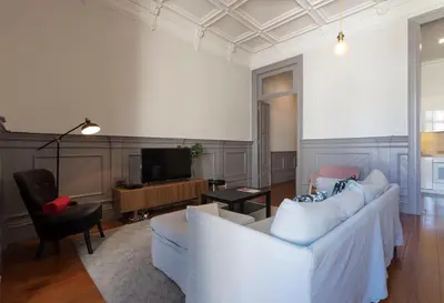 a living room with two white couches and a television at Porto Garden Villa in Porto