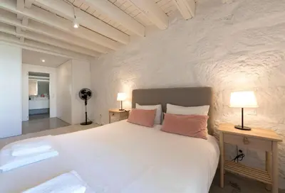 a bedroom with a large white bed with two lamps at Porto Garden Villa in Porto