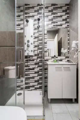 a bathroom with a shower and a white sink at Moreira 284 in Porto