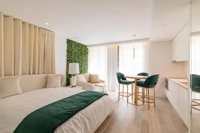 a bedroom with a bed and a table and chairs at OportoLuxApartments in Porto