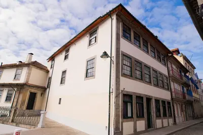 a white building on a street in a city at OportoLuxApartments in Porto
