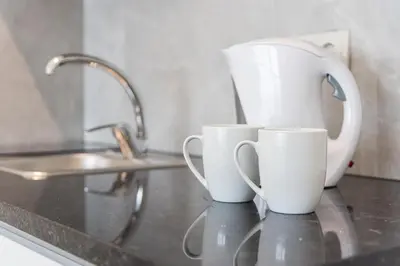 three coffee cups sitting on a counter in a kitchen at River View Building in Vila Nova de Gaia