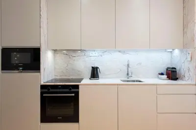 a white kitchen with a sink and a stove at Heart of D Pedro Apartments in Porto