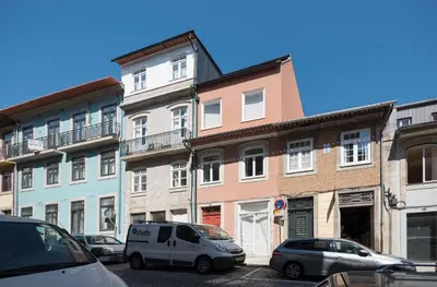 a group of cars parked in front of buildings at Heart of D Pedro Apartments in Porto
