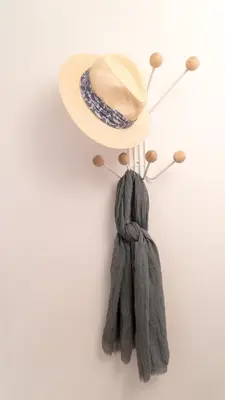 a hat and a scarf hanging on a wall at Souto Apartments in Porto