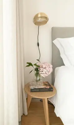 a vase of flowers on a table next to a bed at Souto Apartments in Porto