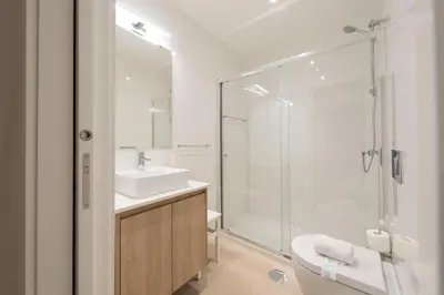 a bathroom with a sink and a glass shower at Heart of D. Pedro Apartments III in Porto