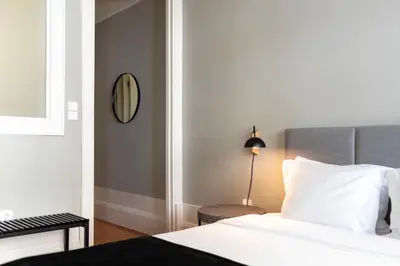 a bedroom with a bed and a mirror on the wall at Cedofeita Premium Apartment 1F in Porto