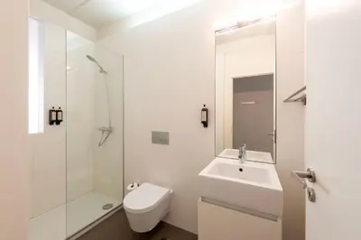 a white bathroom with a sink and a toilet at Cedofeita Premium Apartment 1F in Porto