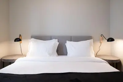 a bedroom with a large white bed with two lamps at Cedofeita Premium Apartment 1B in Porto
