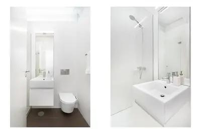 a white bathroom with a sink and a toilet at Cedofeita Premium Apartment 2F in Porto