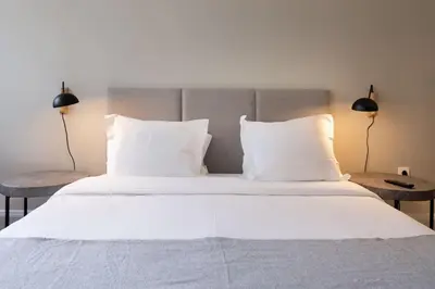a large bed with white sheets and pillows at Cedofeita Premium Apartment 2F in Porto