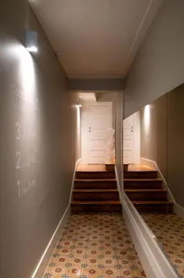 a hallway with stairs and a white door and a room at Cedofeita Premium Apartment 2F in Porto