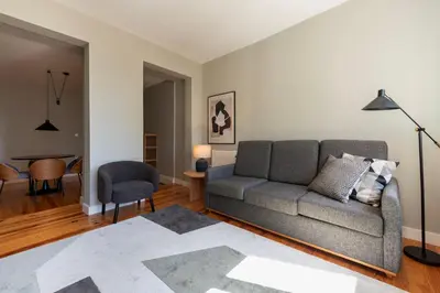 a living room with a couch and a table at Cedofeita Premium Apartment 2B in Porto