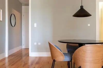 a dining room with a table and chairs at Cedofeita Premium Apartment 2B in Porto