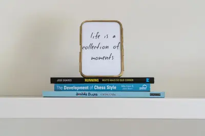 a stack of books on a shelf with a mirror at Kings Oporto Apartments in Porto