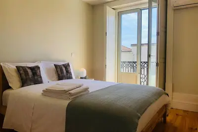 a bedroom with a bed with towels on it at CL Freixo Apartment in Porto