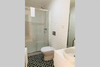 a bathroom with a toilet and a shower and a sink at CL Freixo Apartment in Porto