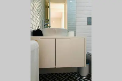 a bathroom with a sink and a white cabinet at CL Freixo Apartment in Porto