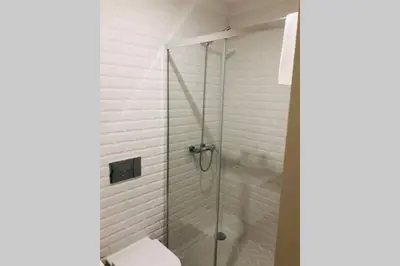 a glass shower with a toilet in a bathroom at CL Freixo Apartment in Porto