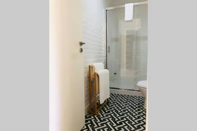 a bathroom with a toilet and a glass shower at CL Freixo Apartment in Porto