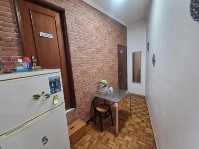 a kitchen with a small table and a brick wall at Truz truz2 in Porto
