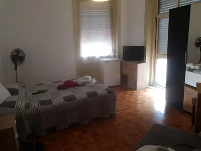 a bedroom with a bed and a television in it at Truz truz4 in Porto