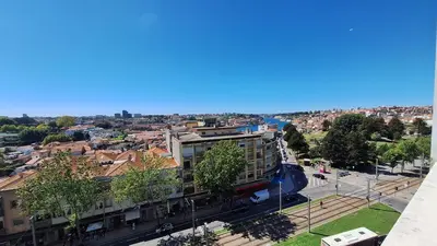 a white coffee table in a living room with a couch at Apartamentos Jardim do Morro in Vila Nova de Gaia