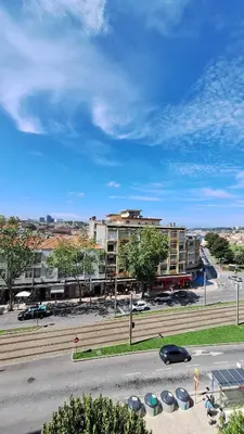 a living room with a table and a couch at Apartamentos Jardim do Morro in Vila Nova de Gaia