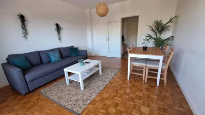 a living room with a couch and a table at Apartamentos Jardim do Morro in Vila Nova de Gaia