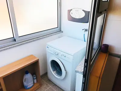 a washer and dryer in a tiny house at Azulejos Apartment in Porto