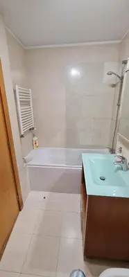 a bathroom with a tub and a sink and a bath tub at Azulejos Apartment in Porto
