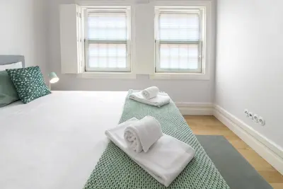 a bedroom with a bed with towels on it at MSC Flat 8 in Porto