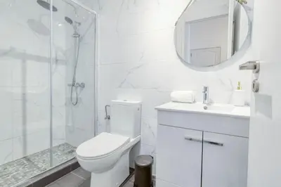 a white bathroom with a toilet and a sink at Travel & live Santa Catarina apartment in Porto