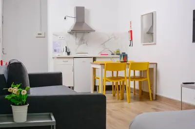 a living room with a couch and yellow chairs at Travel & live Santa Catarina apartment in Porto