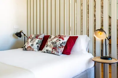 a white bed with two pillows on top of it at Light-filled Bonjardim Apartments in Porto