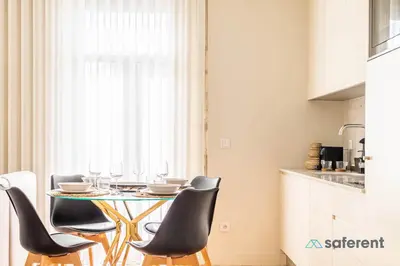 a dining room with a table and chairs in a kitchen at Light-filled Bonjardim Apartments in Porto