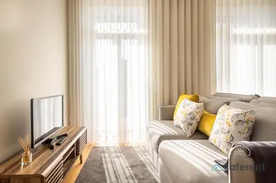 a living room with a couch and a tv at Light-filled Bonjardim Apartments in Porto